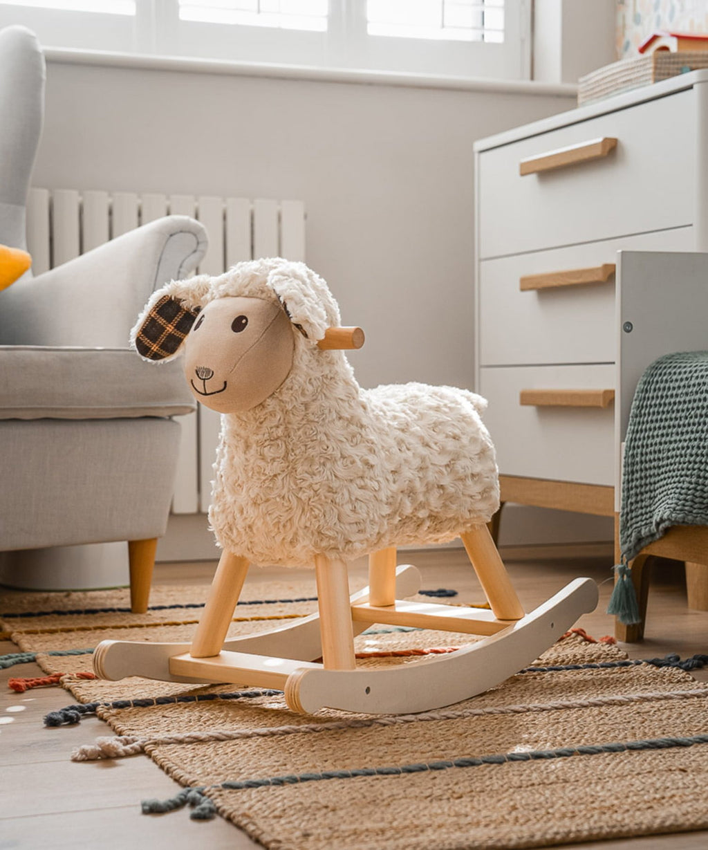 Cream plush rocking sheep with wooden rocker frame and plaid ear patch detail.