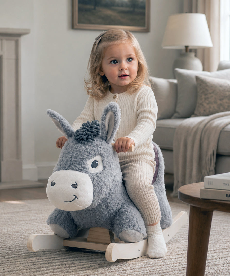 Little girl riding Bojangles Rocking Donkey with soft padded seat