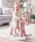 Girl riding a pink rocking horse
