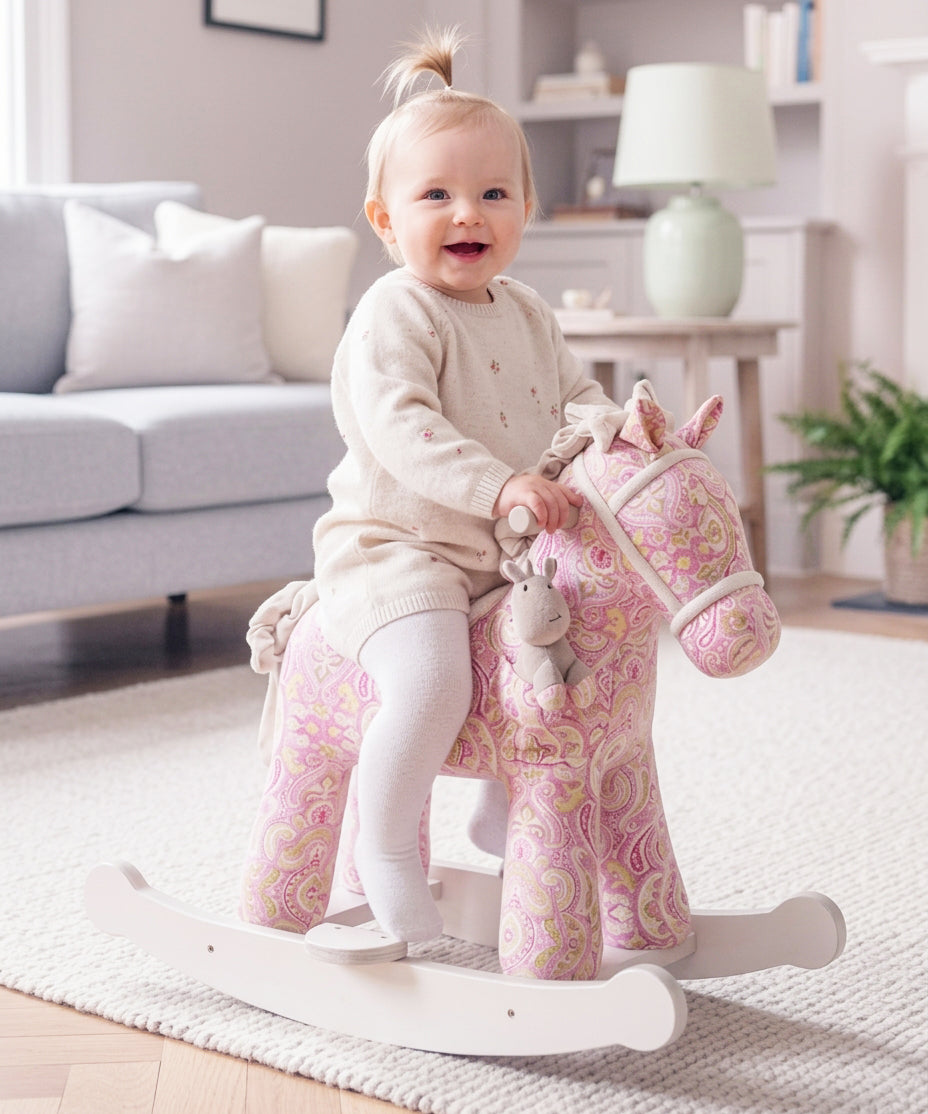 Girl riding a pink rocking horse