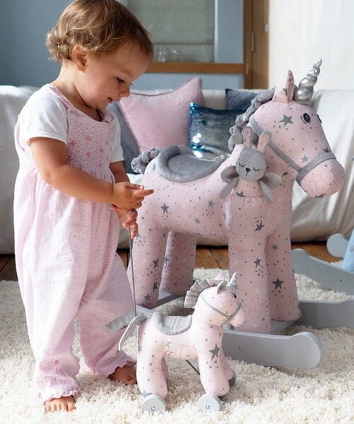 Toddler playing with Celeste & Fae Rocking Unicorn and Celeste Unicorn Pull Along Toy