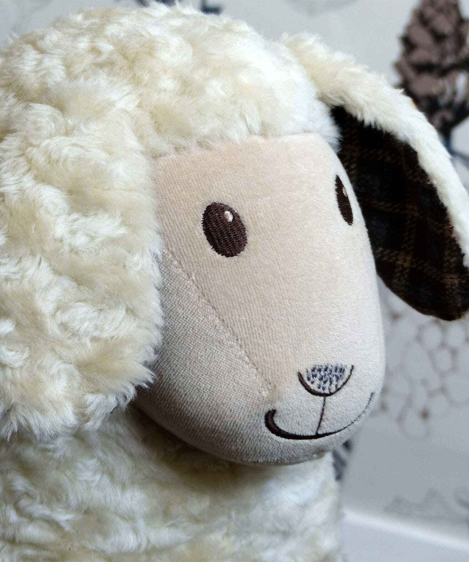 Close up of Lambert Rocking Sheep highlighting cute embroidery details on his face