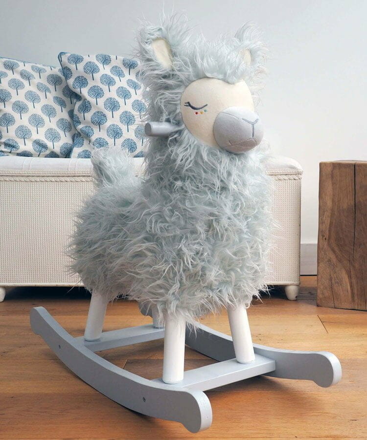 Rio Rocking Llama with solid wooden frame, stands on a wooden floor