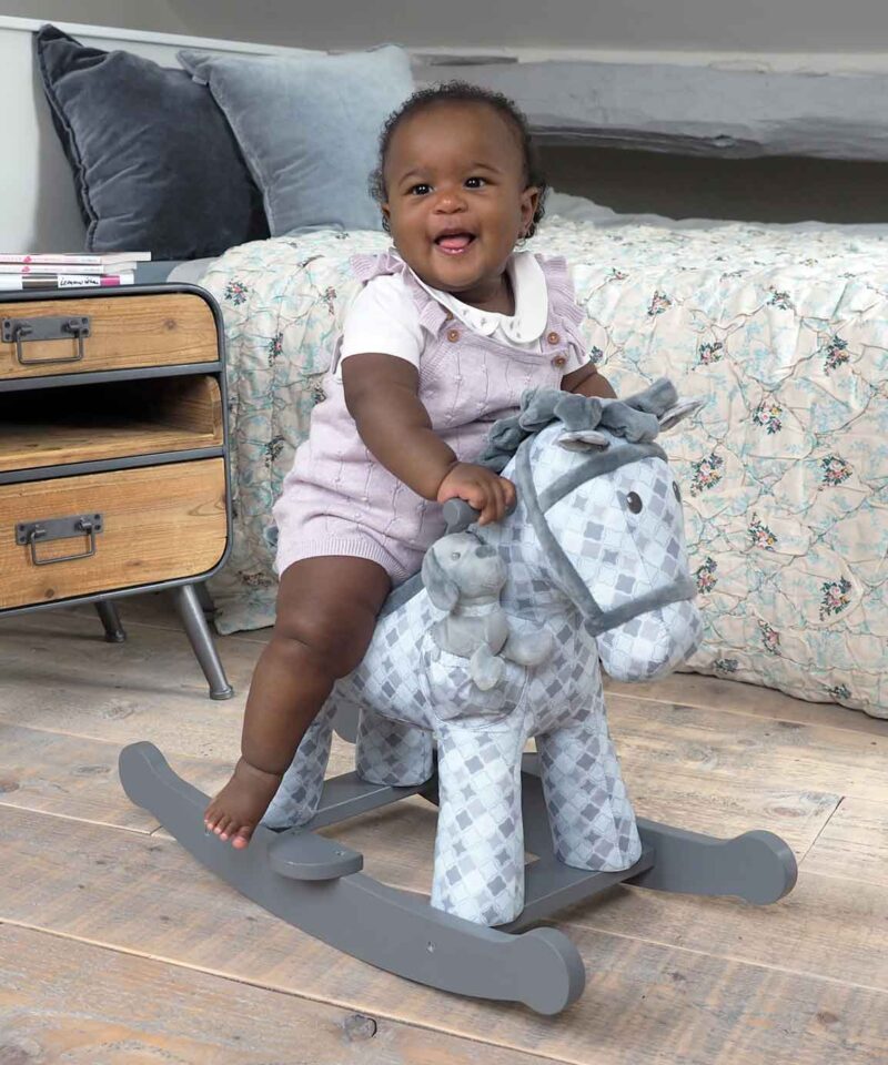 Baby Girl riding baby rocking horse Harper & Chase featuring a grey geometric printed fabric 