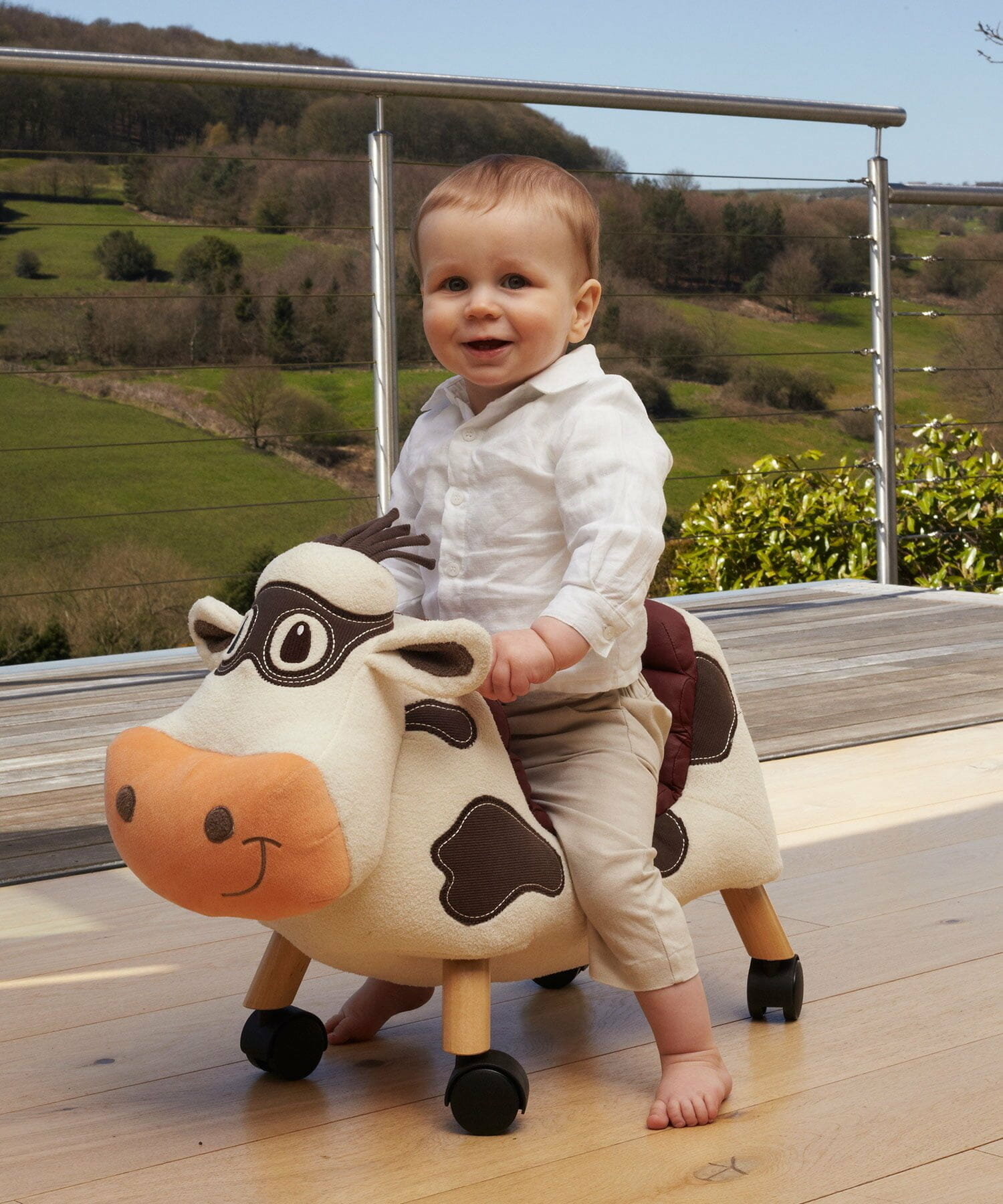 Little boy riding Moobert Cow Ride On Toy for toddlers