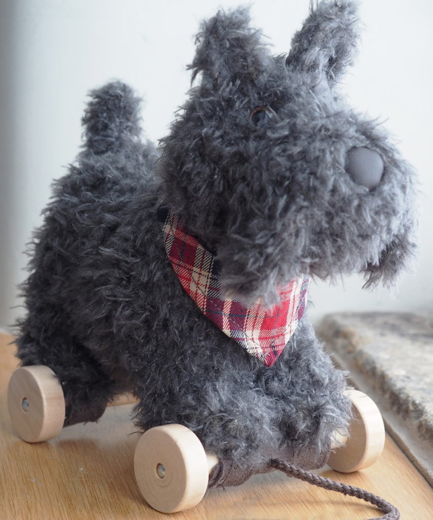 Close up of Scottie Dog Pull Along Toy on removable wheels