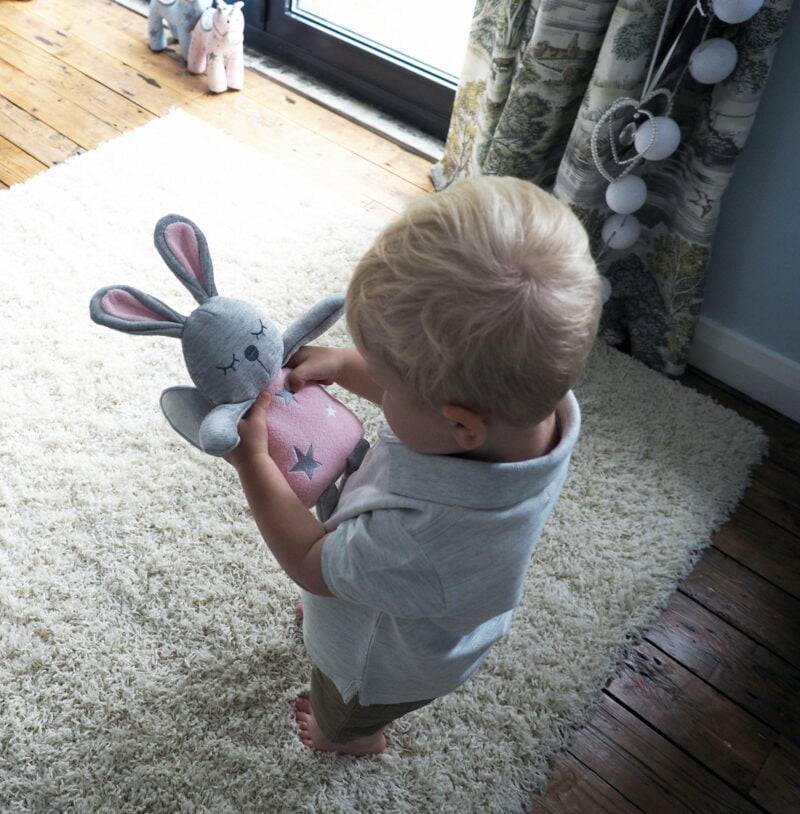 Little boy playing with  Fae Fairy Hug Toy