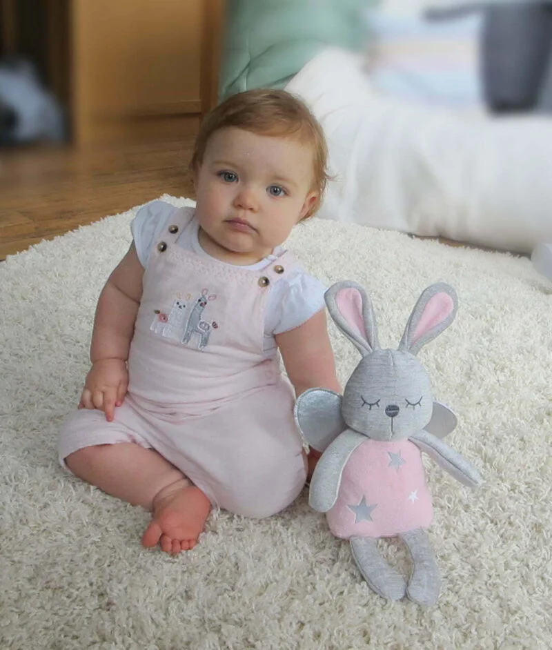 Girl with her Fae Fairy Hug Toy, both wearing pink