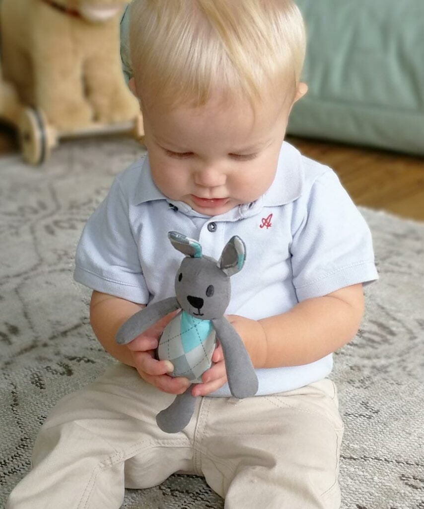 Little boy playing with cute Little Fitz Rabbit toy