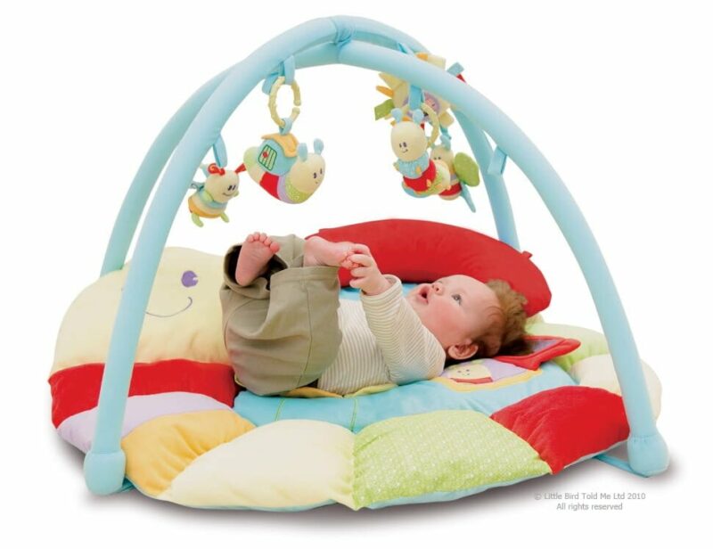 Baby lying on Softly Snail Multi-Activity Playgym in bright primary colours 
