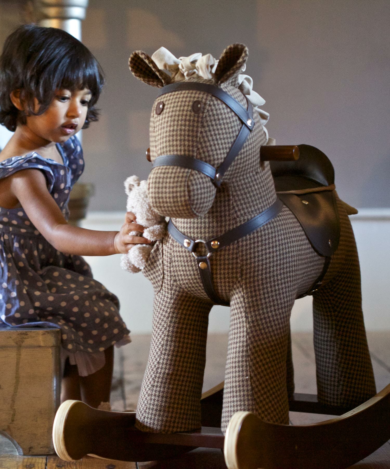 Little girl playing with Chester & Fred Rocking Hrse with luxury hounds tooth fabric