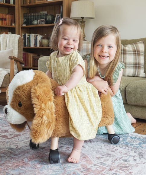 Toddler Girl and Sister playing with Peanut Pup Ride On Toy in living room Ride on toys for toddlers
