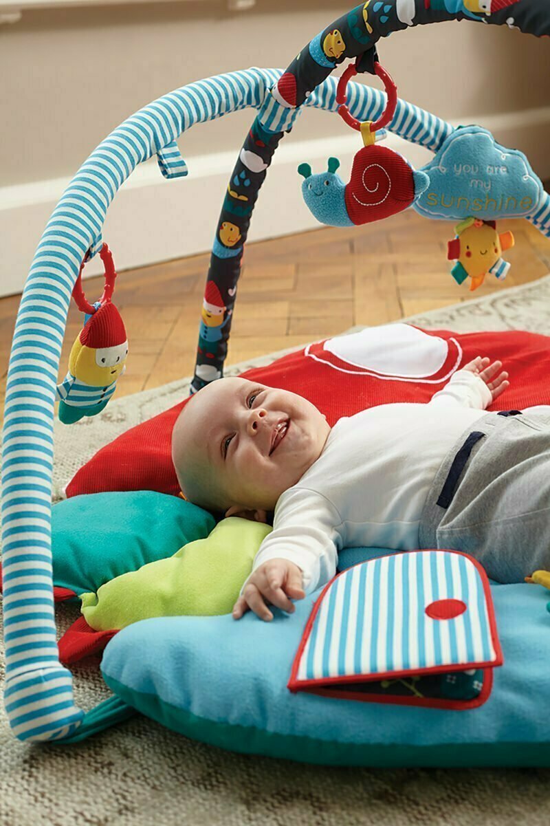 Baby laid on thick padded My Little Sunshine Activity Playgym suitable for hard floors