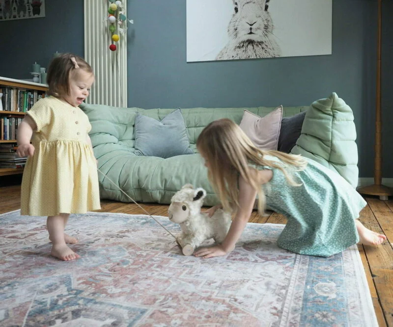 girls playing with sheep teddy 