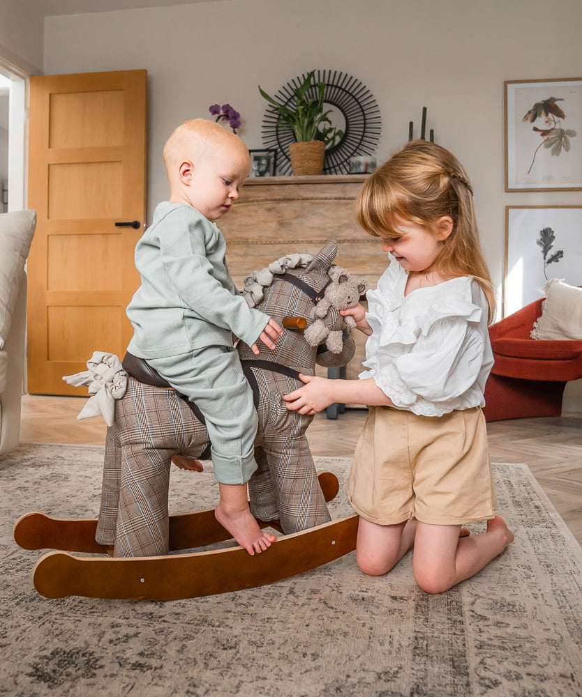 Siblings playing with Jasper rocking horse