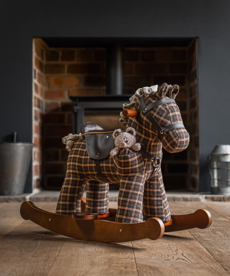 Rufus and Ted Rocking horse on wooden floor in living room 