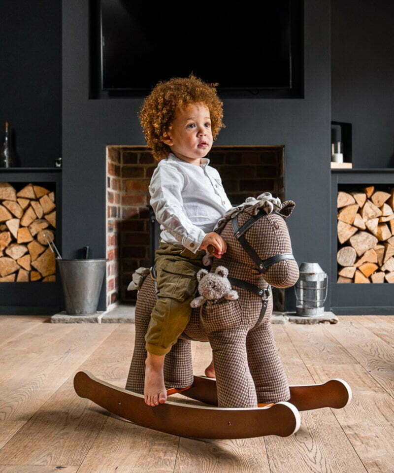 little boy laughing on chester and fred rocking horse