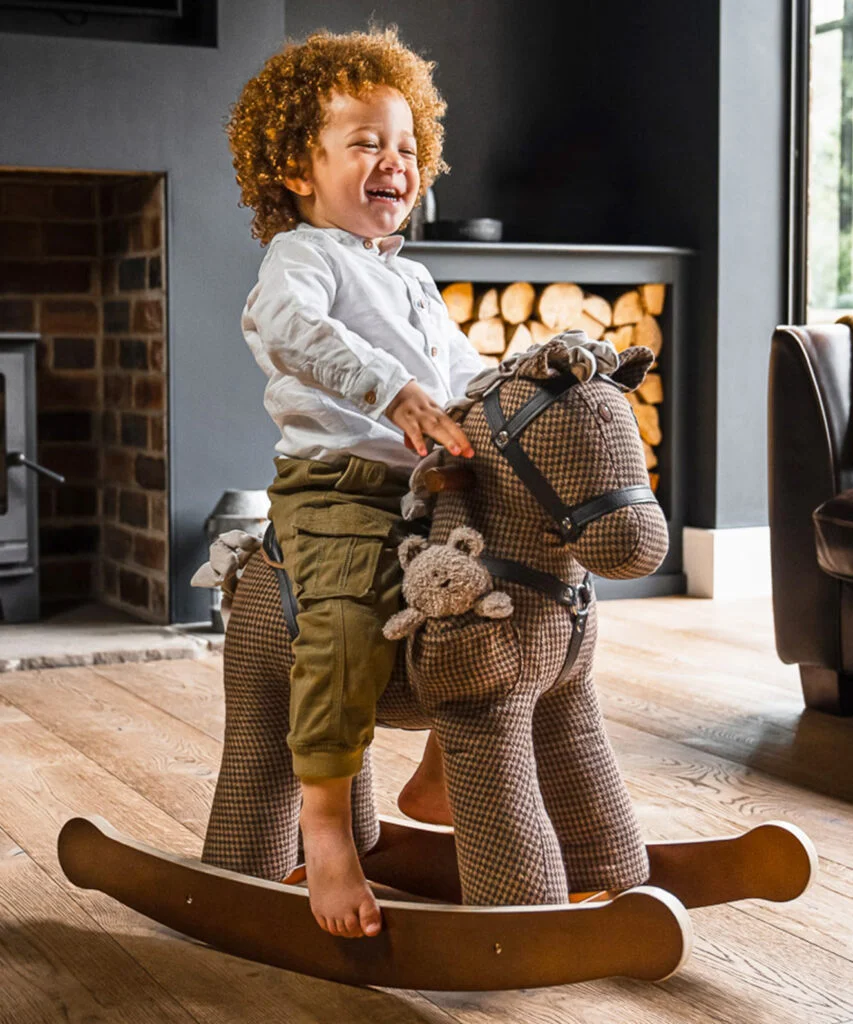 Toddler boy rocking on Chester and Fred rocking horse 