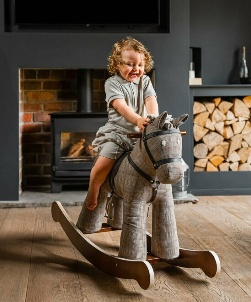little boy playing on jasper rocking horse for 1 year old 