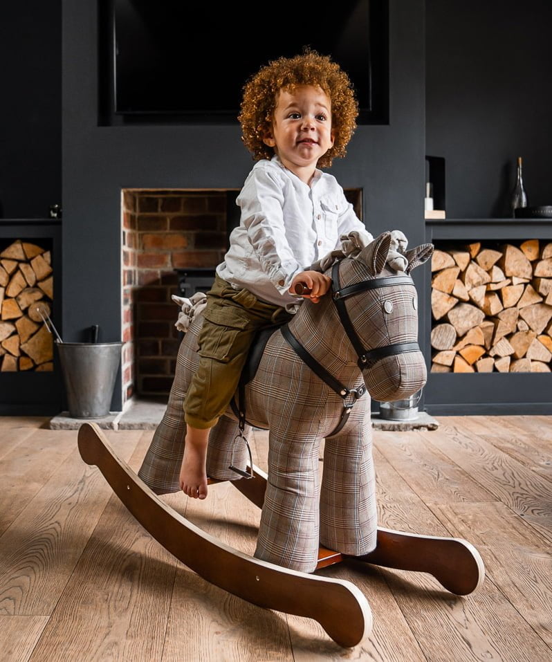 toddler boy riding on jasper rocking horse for 18 months 