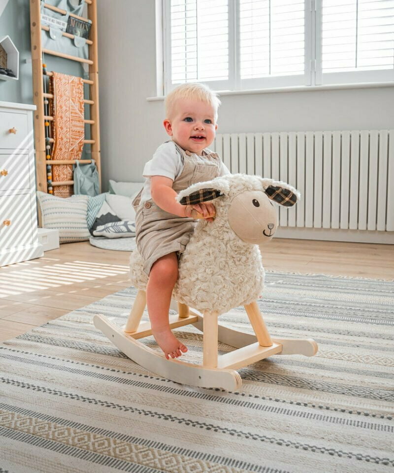 Little boy in nursery room on lambert rocking sheep 