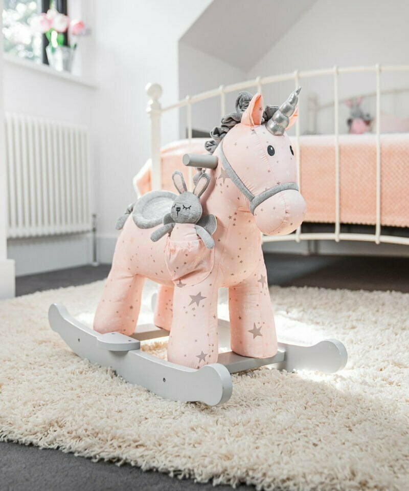 unicorn rocking horse in pink room 