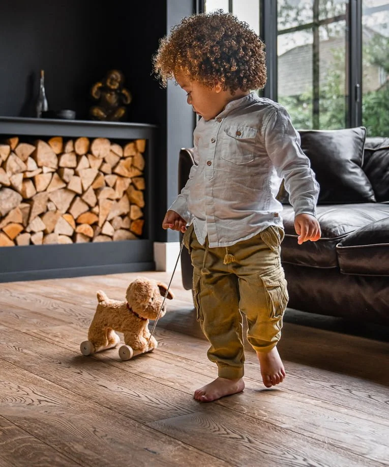 little boy pulling toy dog to walk 