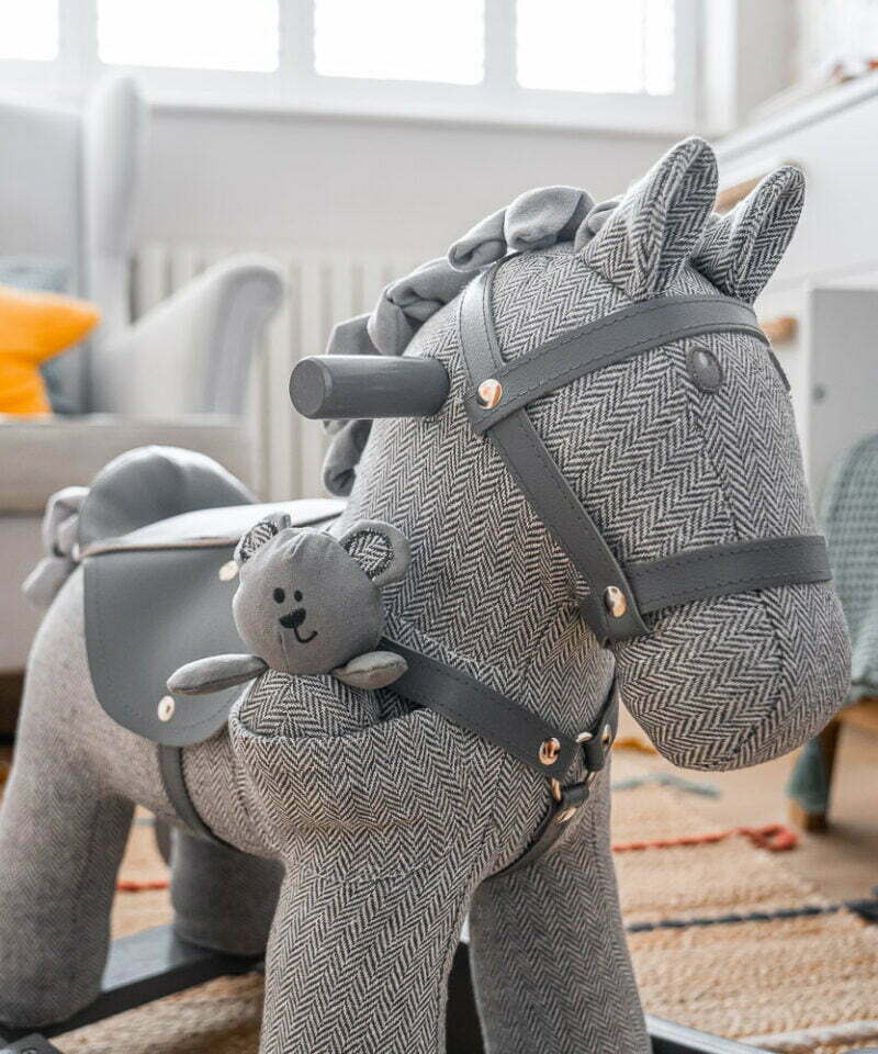 grey rocking horse in grey nursery room 