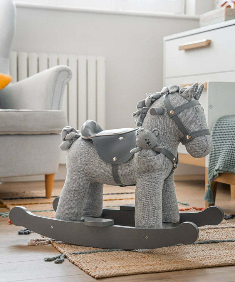 grey rocking horse in nursery room 