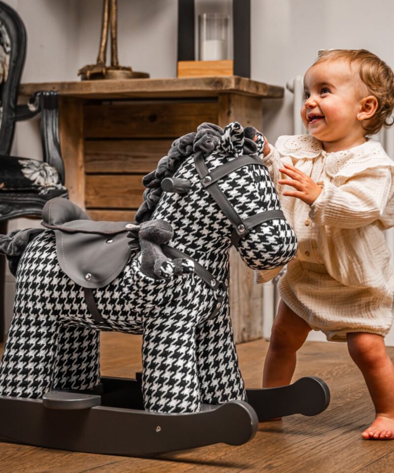 little girl playing with herringbone horse 