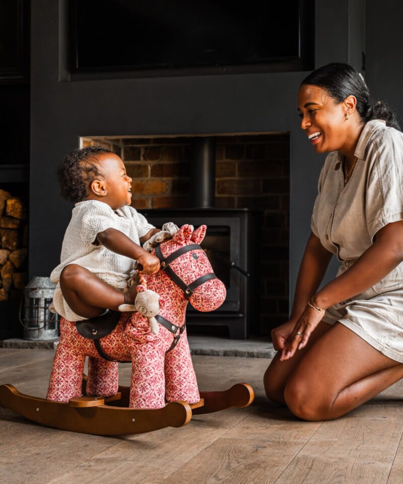 little girl and mum playing with cooper and beau rocking horse