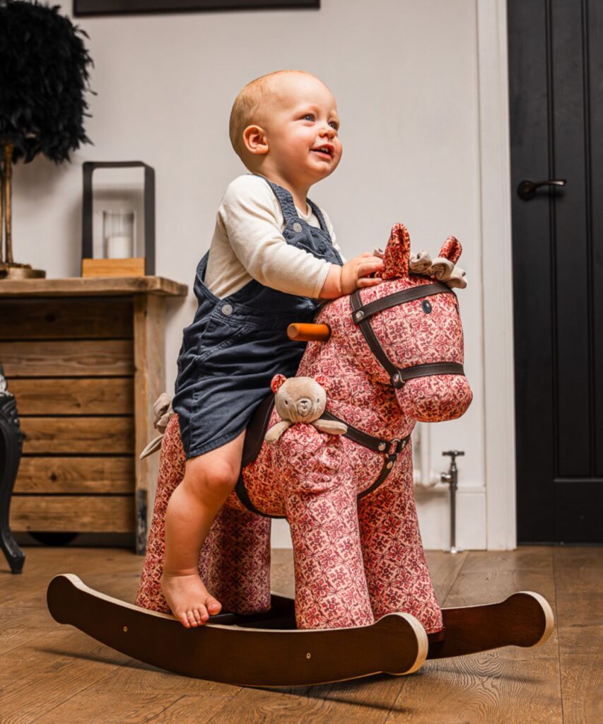 Little boy on cooper & beau riding toys for one year olds