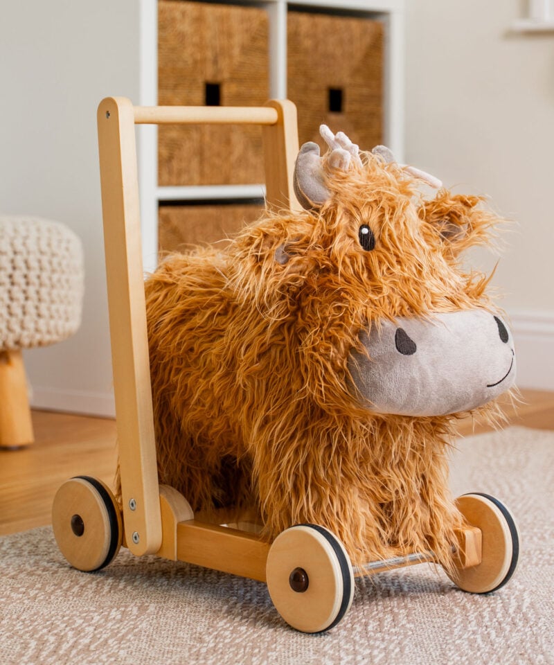 Highland cow baby walker in a playroom
